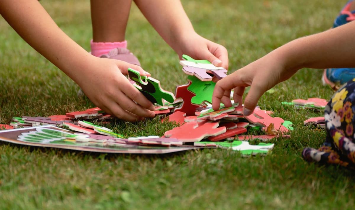 Children playing with foam puzzle pieces